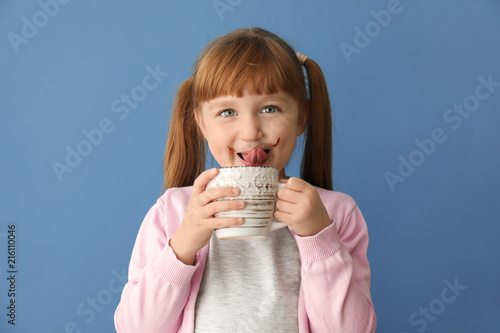 Cute little girl with cup o...