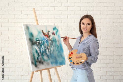 Young female artist with dr...