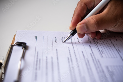 Wallpaper Mural Close-up of hand writing paper at the desk with pen and reading books at table with  working in office Torontodigital.ca