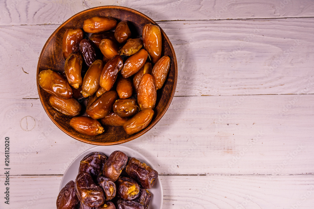 Date fruits on the white wooden table. Top view Date fruits on the white wooden table. Top view