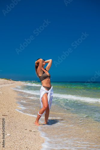 woman sunbathing on the beach photo