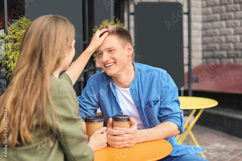 Happy young couple in cafe ...