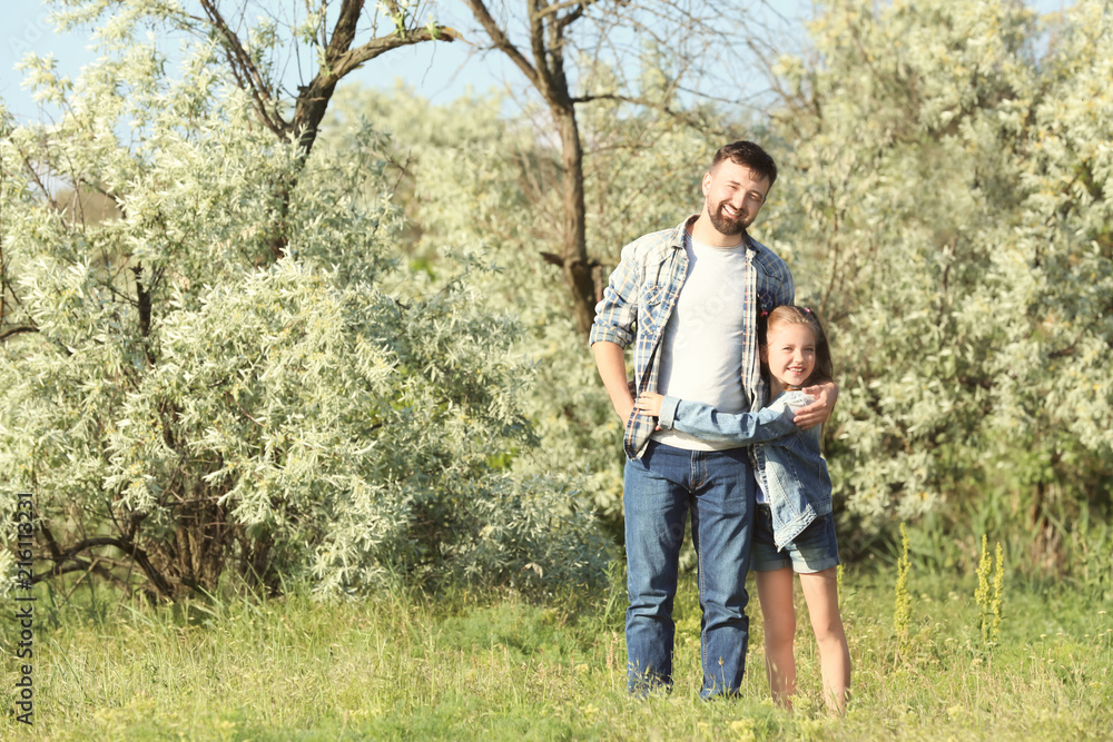 Happy father and little daughter in park on sunny day Happy father and little daughter in park on sunny day