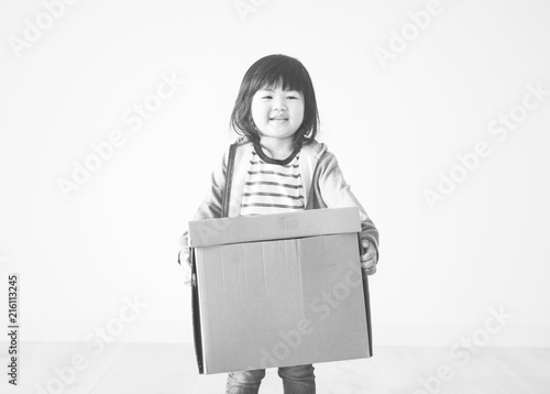 Asian kid helping to move to a new house