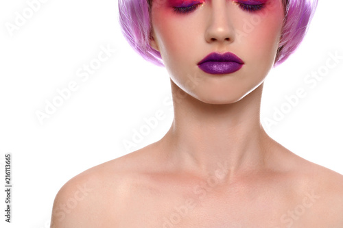 Young woman with unusual hair and professional makeup on white background