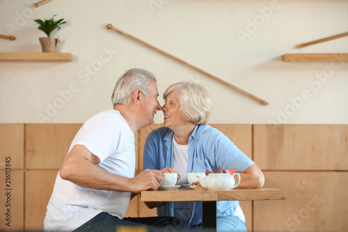 Happy senior couple sitting together in cafe