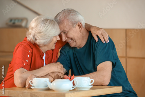 Happy senior couple sitting...