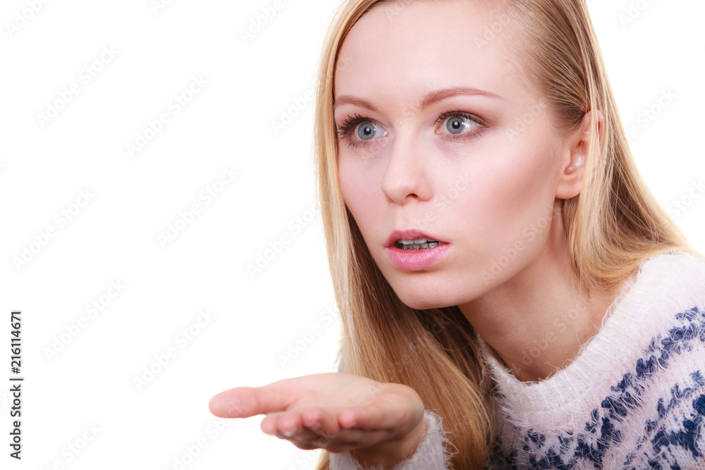 Blonde womn sending air kiss on palm hand Blonde womn sending air kiss on palm hand