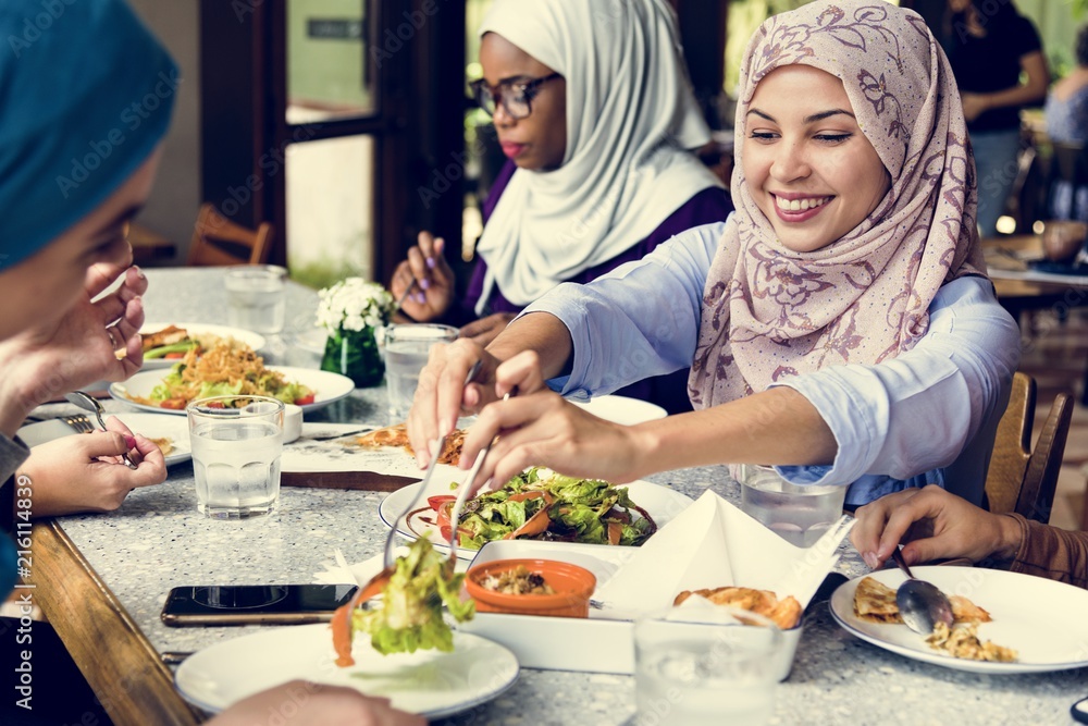 Islamic women friends dining together with happiness