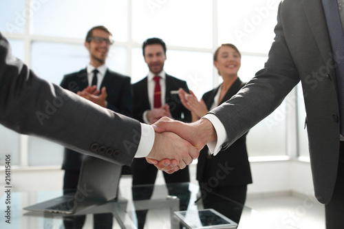 business handshake over blurry background office © ASDF