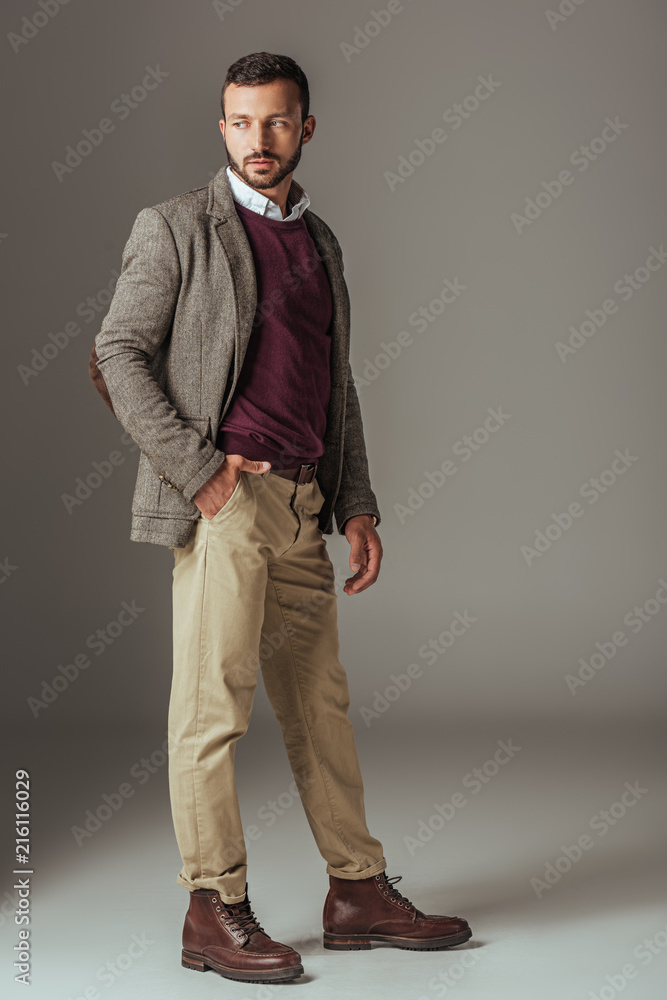 bearded man posing in stylish autumn tweed jacket, on grey bearded man posing in stylish autumn tweed jacket, on grey