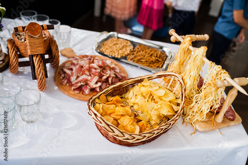 Close-up photo of cheese and meat assortment and other salty snacks on the wedding buffet.