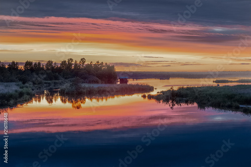 Pink sunset on the lake shore © Maksim