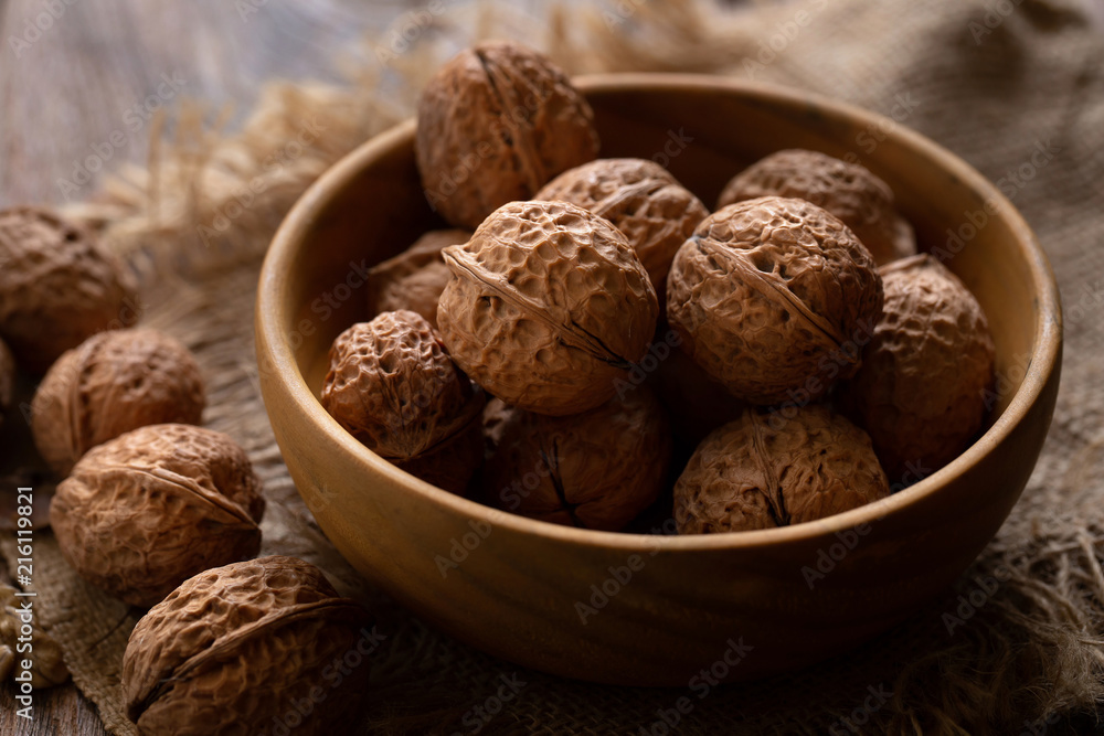 Walnuts kernels in wooden bowl, Walnut healthy food Top view Walnuts kernels in wooden bowl, Walnut healthy food Top view