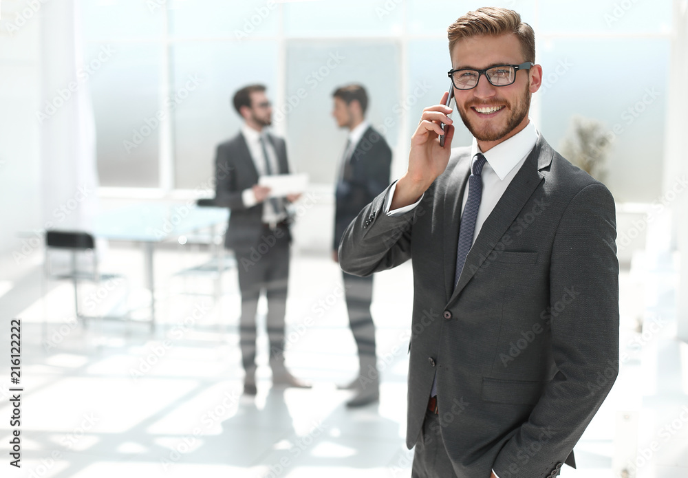 businessman with mobile phone standing next to the Bank office businessman with mobile phone standing next to the Bank office