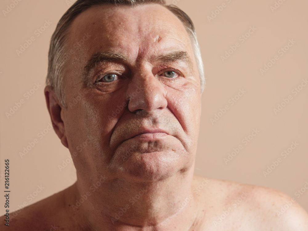 Obraz premium Aged man portrait on light background.