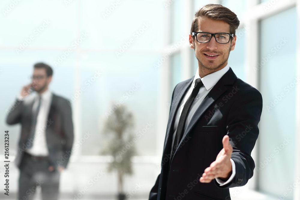 successful businessman reaching out for a handshake successful businessman reaching out for a handshake
