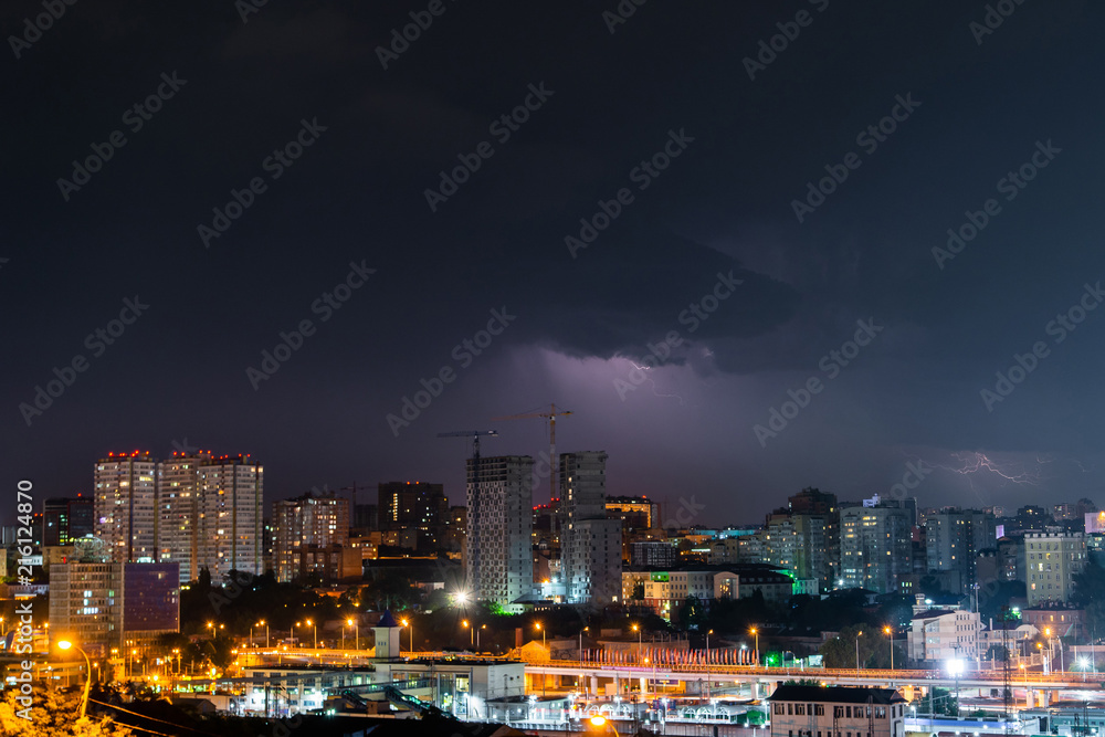 Thunder, lighting and storm in dark night sky above city