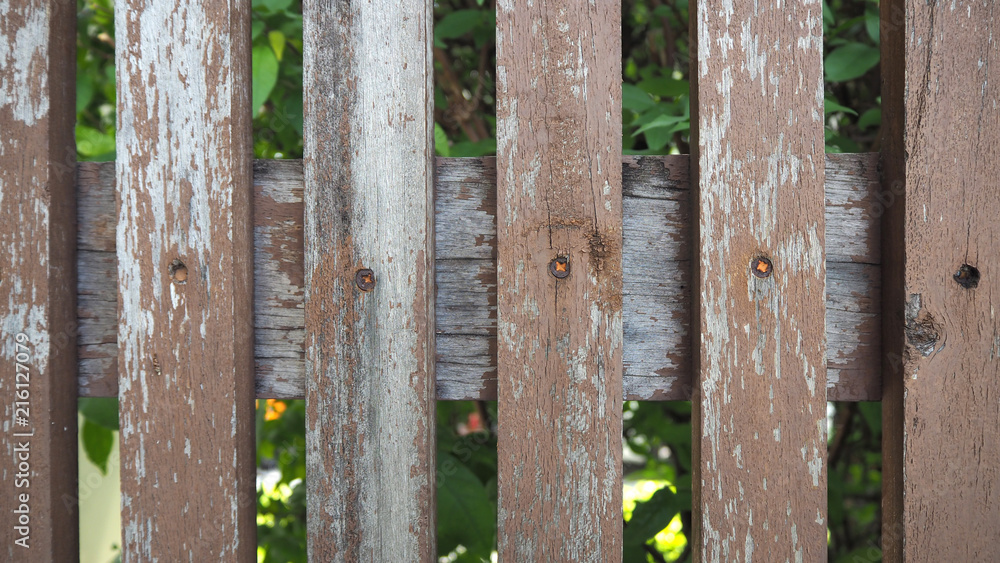 Old wooden fence. trees full of leaves behind an old wooden fence. Old wooden fence. trees full of leaves behind an old wooden fence.
