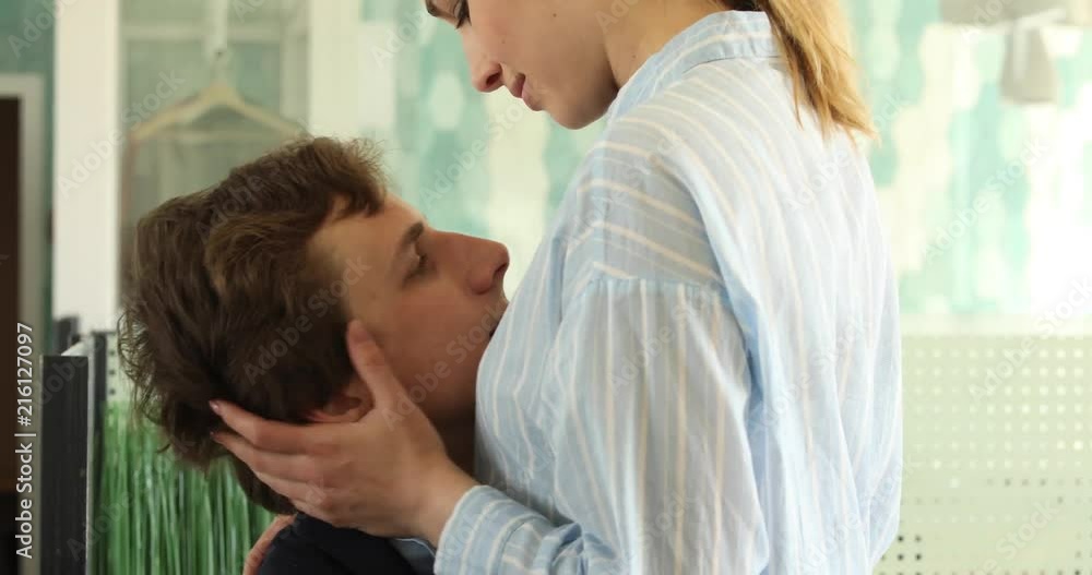 Young man and woman in formal clothes about to have sex in office on table desk Young man and woman in formal clothes about to have sex in office on table desk