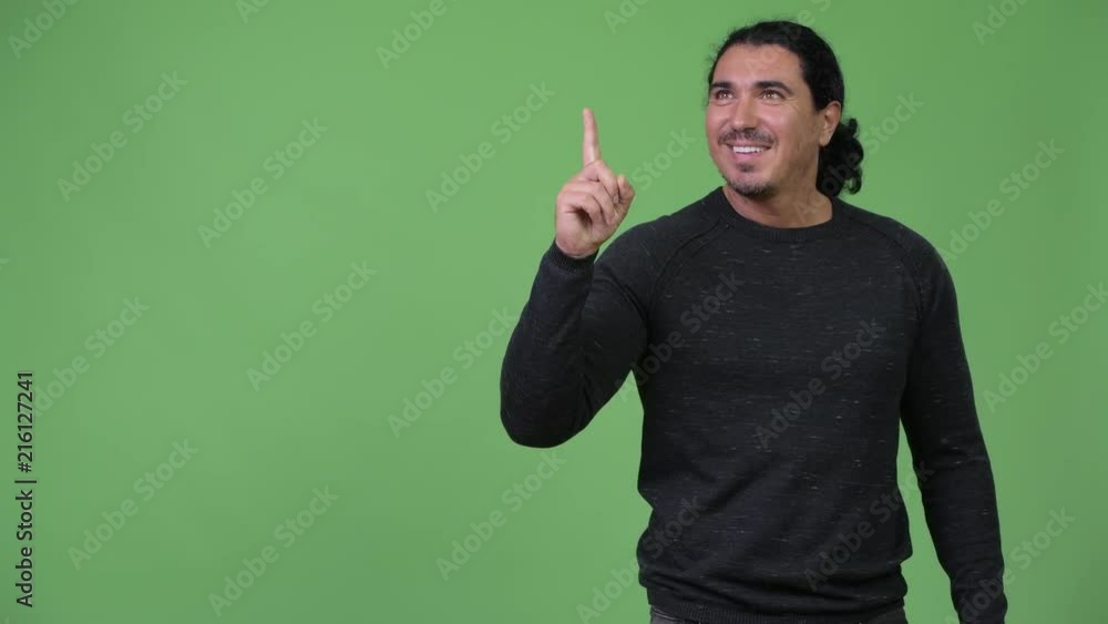 Handsome man thinking while pointing finger up Handsome man thinking while pointing finger up
