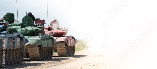 several tanks standing in a lile on the ground. Copyspace photo