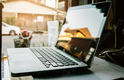 Digital technology laptop on wood in the room,  instagram style filter photo vintage tone