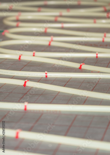 Flexible PVC tubing for high-pressure heated floor systems, custom installed in its' finished layout