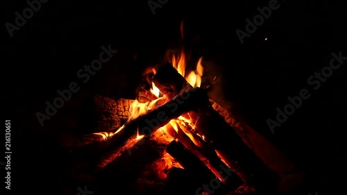 Campfire burning nice in the dark. Firewood in the fire and flames. slow motion