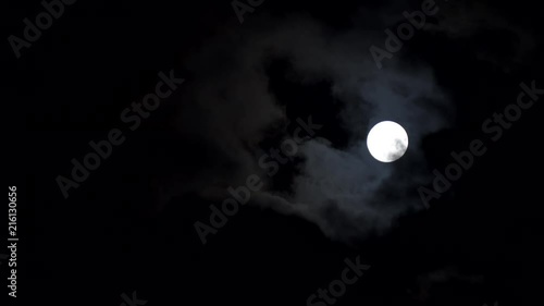Full moon with clouds passing by