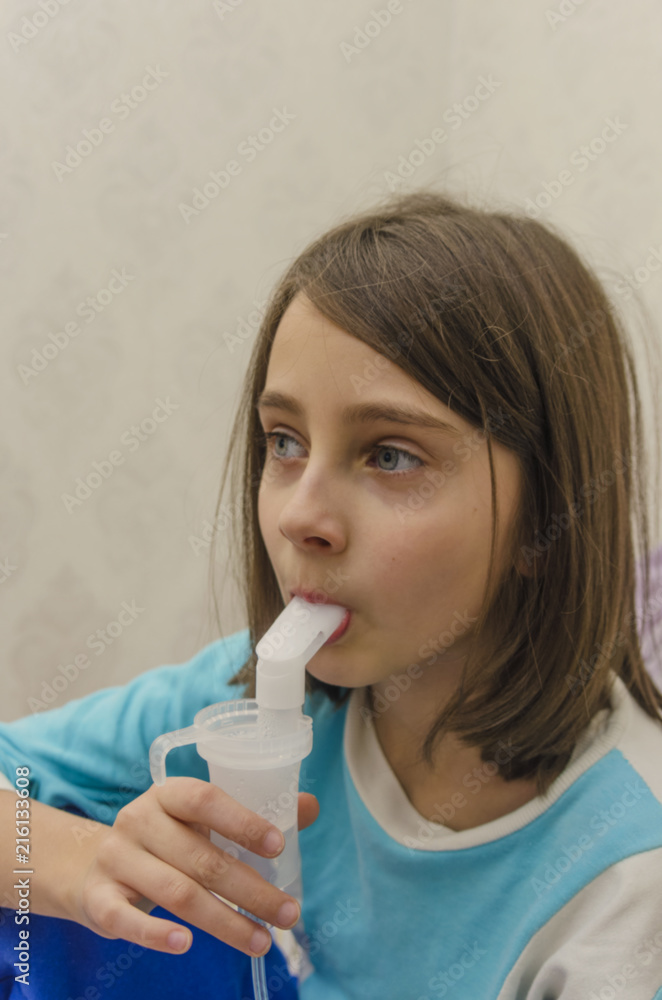 Child using inhaler. Theme of treatment of children's respiratory illness. Treatment of the illness by inhaling medication. Child using inhaler. Theme of treatment of children's respiratory illness. Treatment of the illness by inhaling medication.