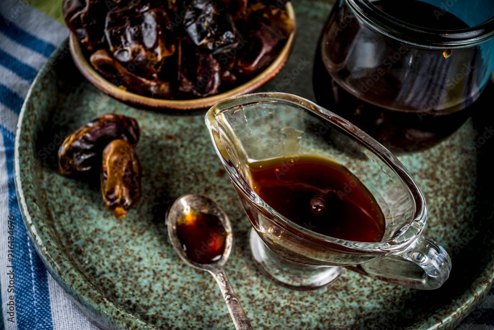 Fototapeta premium Date honey with dried dates, Jewish national sweet food, copy space