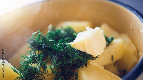 Boiled potatoes in a pan with dill.