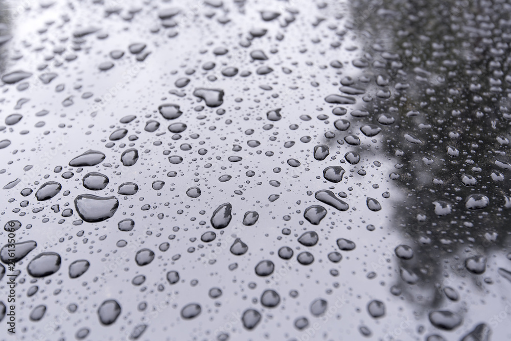 Close-up Drops on a black Car as Background Close-up Drops on a black Car as Background