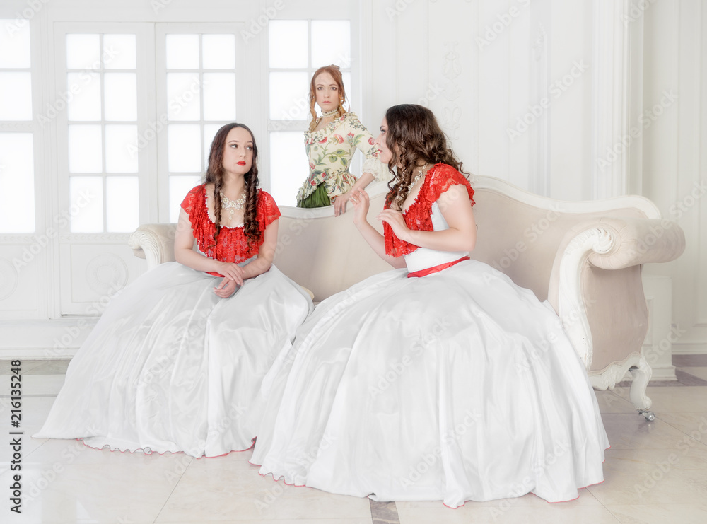 Naklejka premium Three Beautiful woman in medieval dresses talking