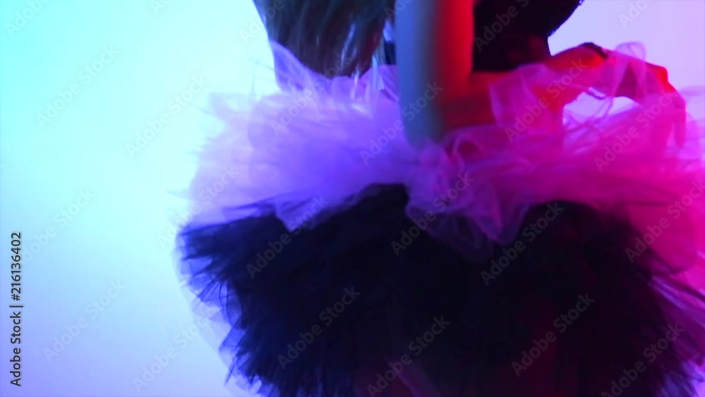 Beauty model girl dancing in short tulle skirt. Sexy young woman with