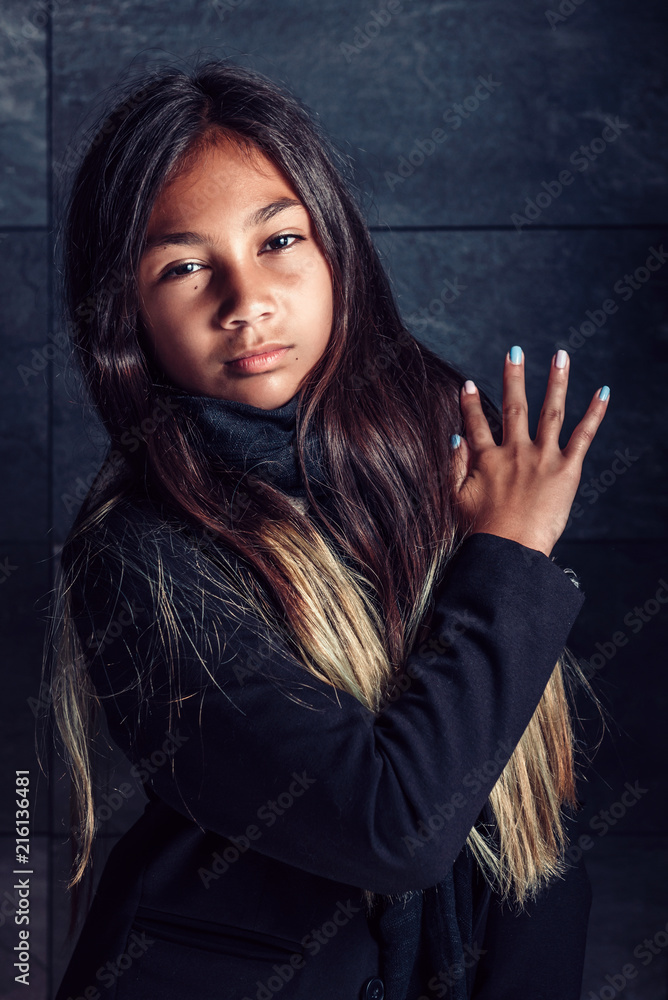 Afro american girl posing in front of black granite wall Afro american girl posing in front of black granite wall