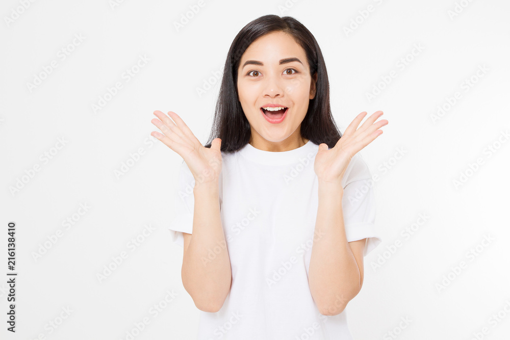 Surprised asian woman in blank white t shirt isolated. Excited and happy young korean girl. Copy space Surprised asian woman in blank white t shirt isolated. Excited and happy young korean girl. Copy space