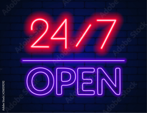 Neon sign 24 7 on brick wall background.