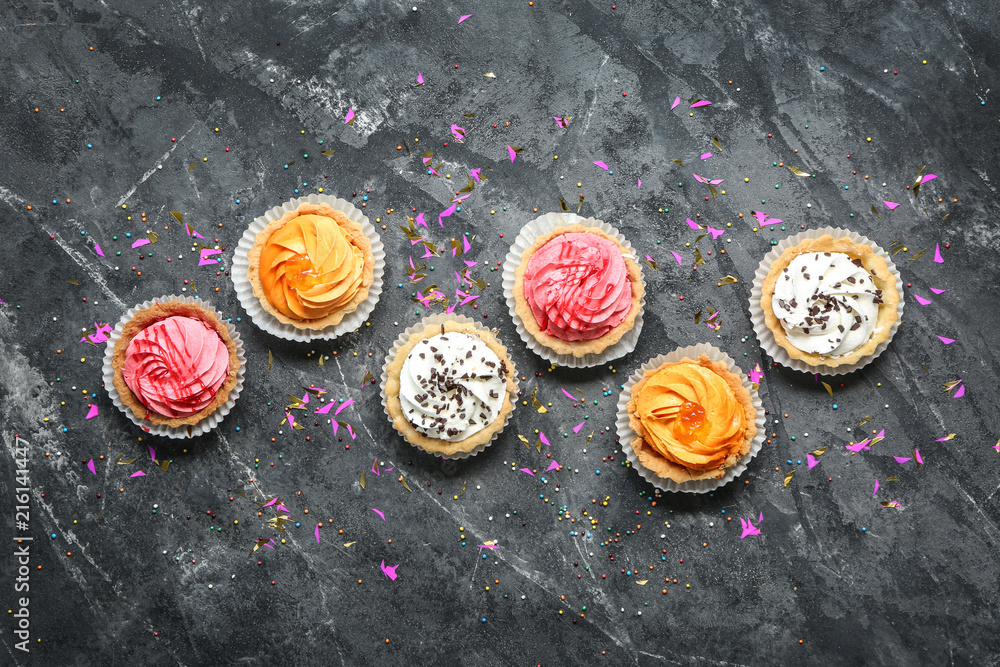 Colorful cupcakes on grey background Colorful cupcakes on grey background