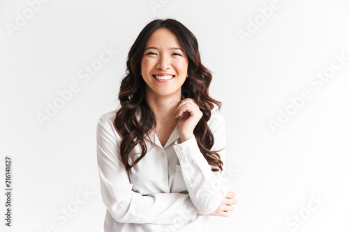 Fotografie Portrait of gorgeous asian woman with long dark hair laughing at camera with bea