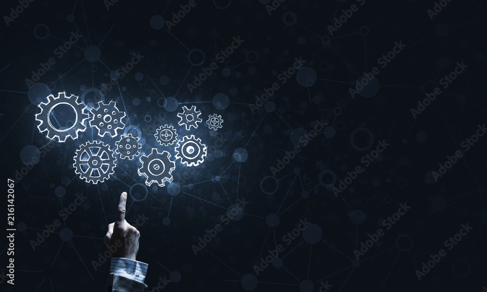 Glowing cogwheel mechanism icon on dark background as symbol of teamwork Glowing cogwheel mechanism icon on dark background as symbol of teamwork