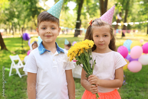Little girl with flowers an...