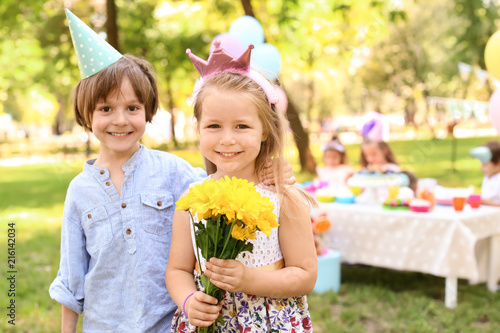 Little girl with flowers an...