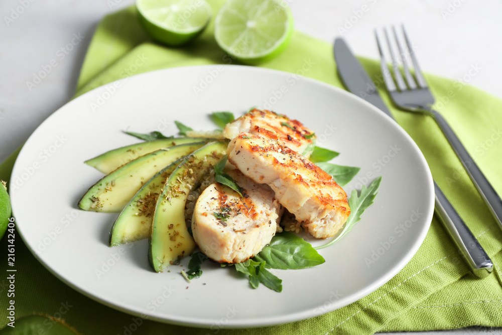 Tasty chicken salad with fresh  herbs and sliced avocado on plate