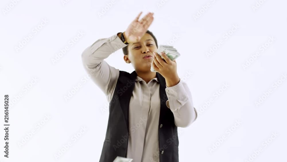 Slowmo studio shot with light background: happy black businesswoman laughing and making it rain money Slowmo studio shot with light background: happy black businesswoman laughing and making it rain money