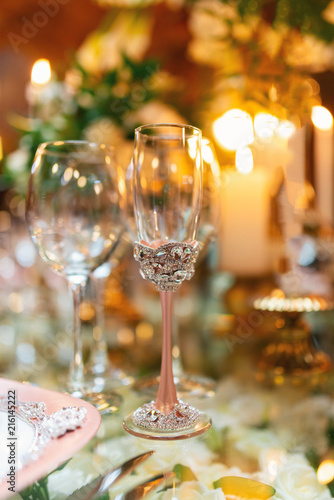 Sparkling glassware stands on table prepared for elegant wedding