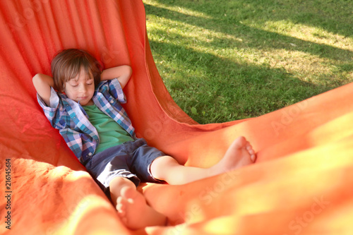 Cute little boy relaxing in...