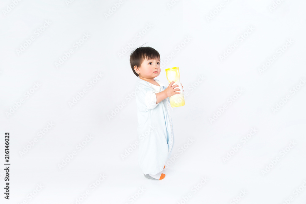 Infant child baby girl kid toddler in diaper make first steps isolated on a white background Infant child baby girl kid toddler in diaper make first steps isolated on a white background