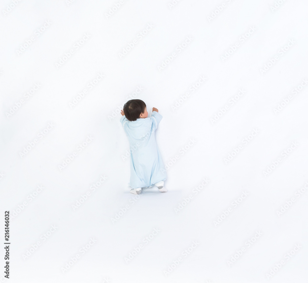 Infant child baby girl kid toddler in diaper make first steps isolated on a white background Infant child baby girl kid toddler in diaper make first steps isolated on a white background